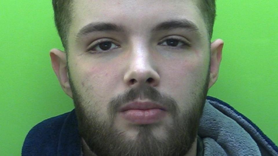 Mugshot of young man called Rocky Price, he has short hair, brown eyes and a beard