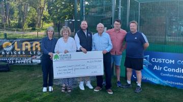 5 people stood in front of the new nets at Edwinstowe Cricket Club with a giant cheque for the funding