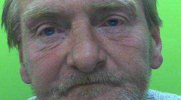 Mug shot of Graham Watson stood in front of a green screen. 